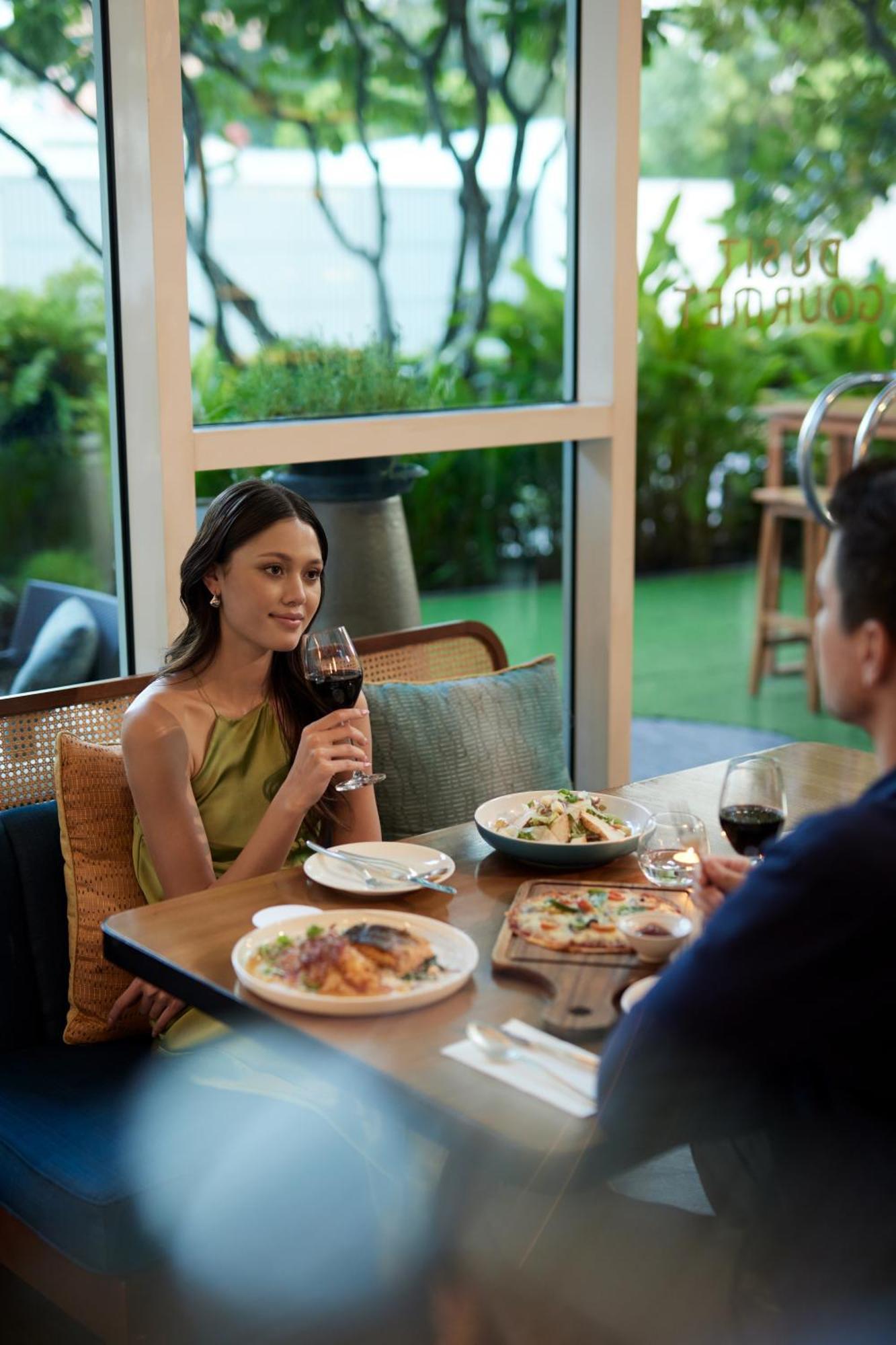 Dusit Suites Hotel Ratchadamri, Bangkok Eksteriør billede A woman drinking wine